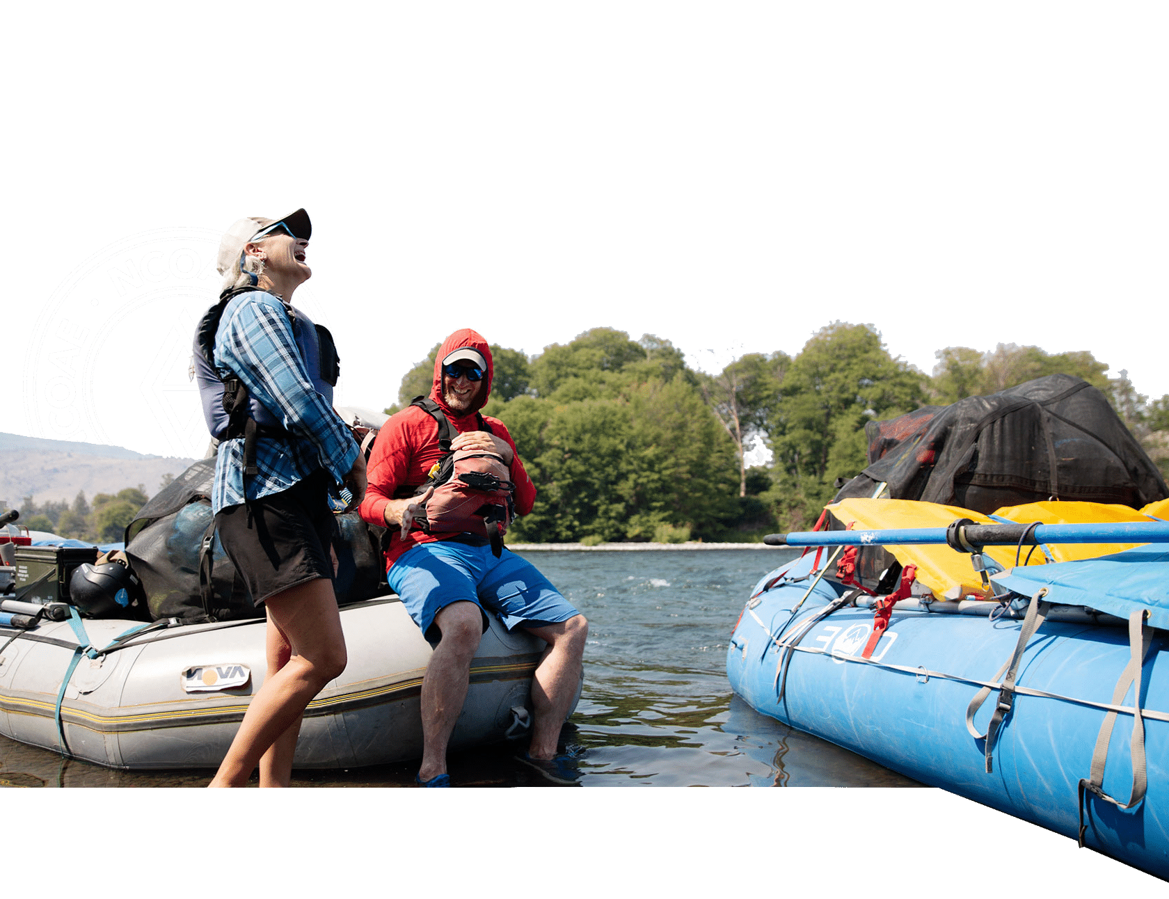 Two people standing on rafts in the water.