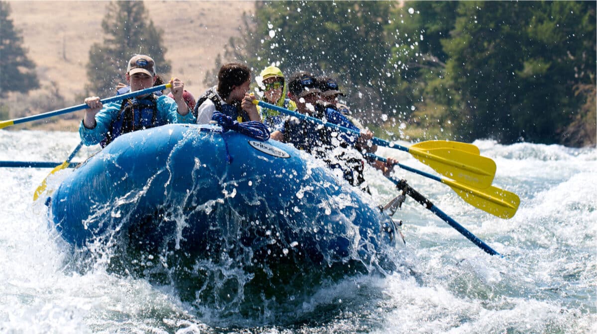 A group of people rafting down a river.