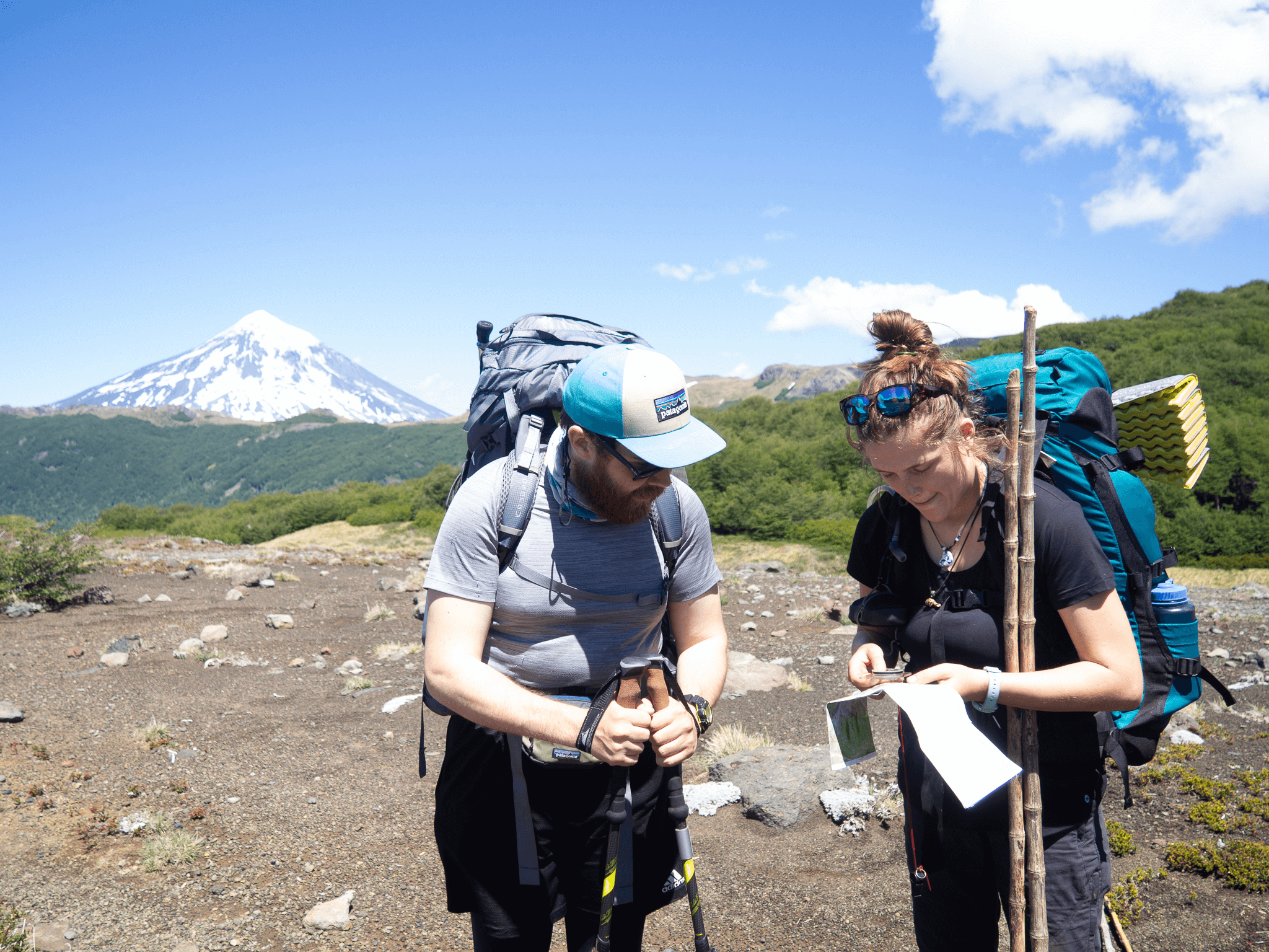 Two NCOAE staff members with hiking gear.