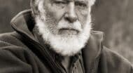 A black and white photo of an older man with a white beard.