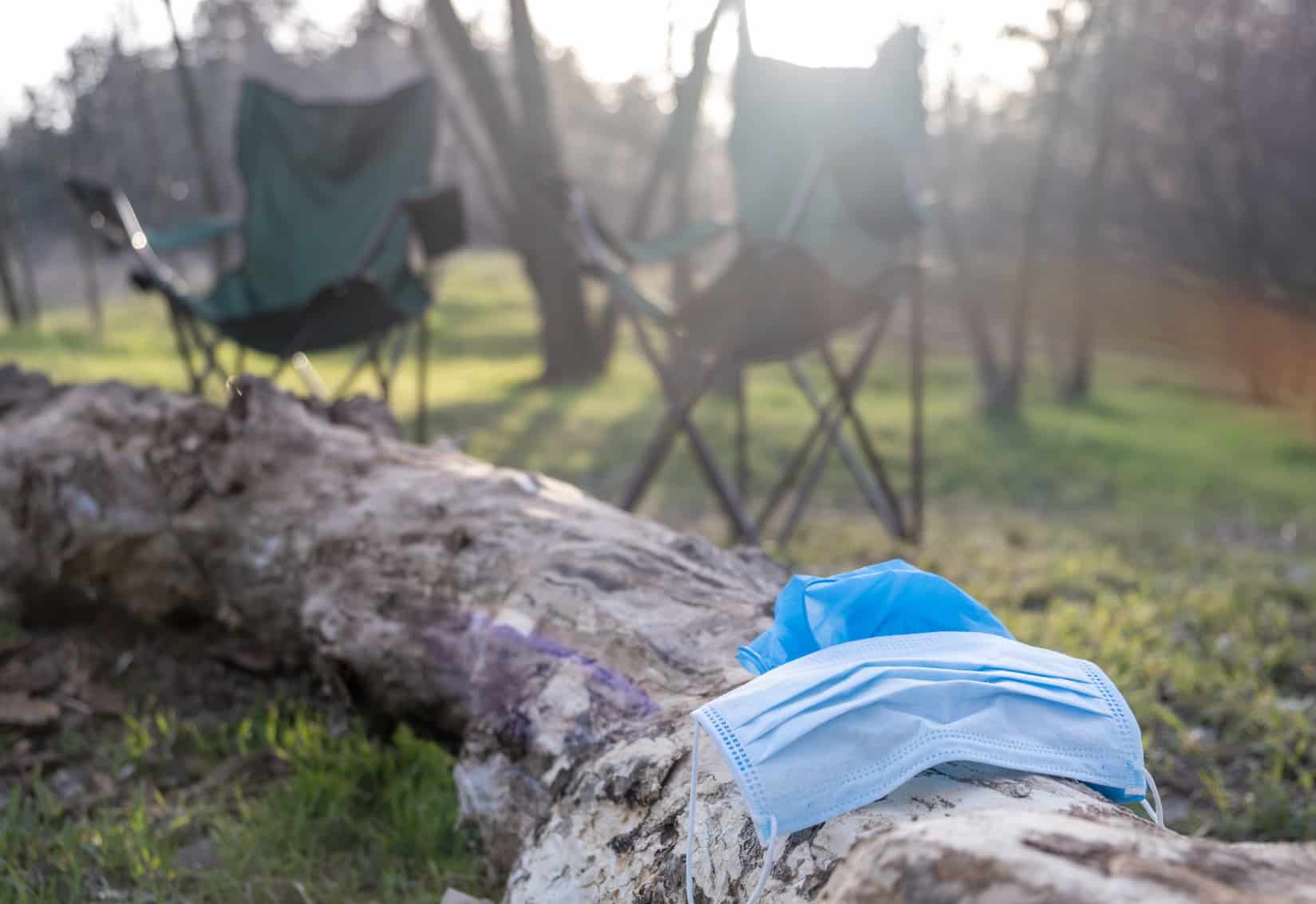 A blue cloth sitting on a log in the woods.