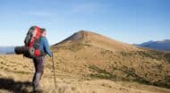 A man hiking with a backpack on a mountain.