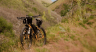 A mountain bike is parked on the side of a trail.