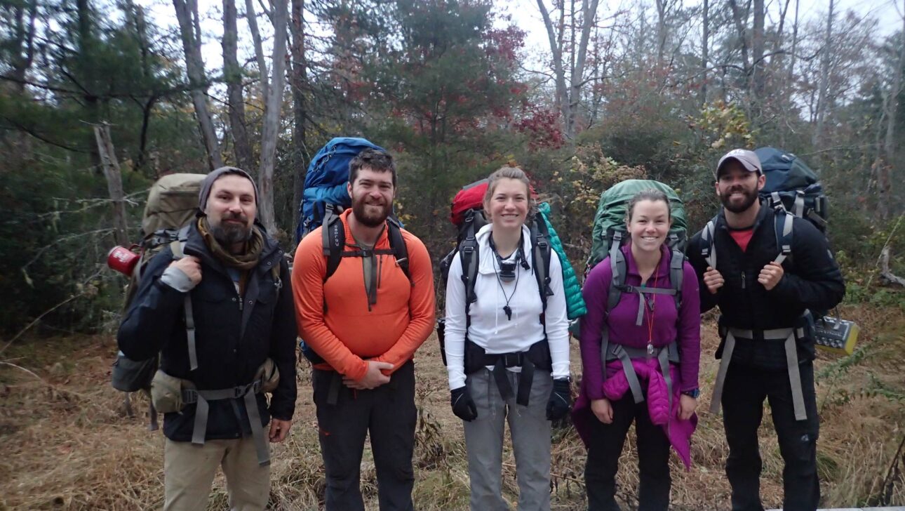 A group of people with backpacking gear.