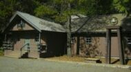 A small cabin in a wooded area.