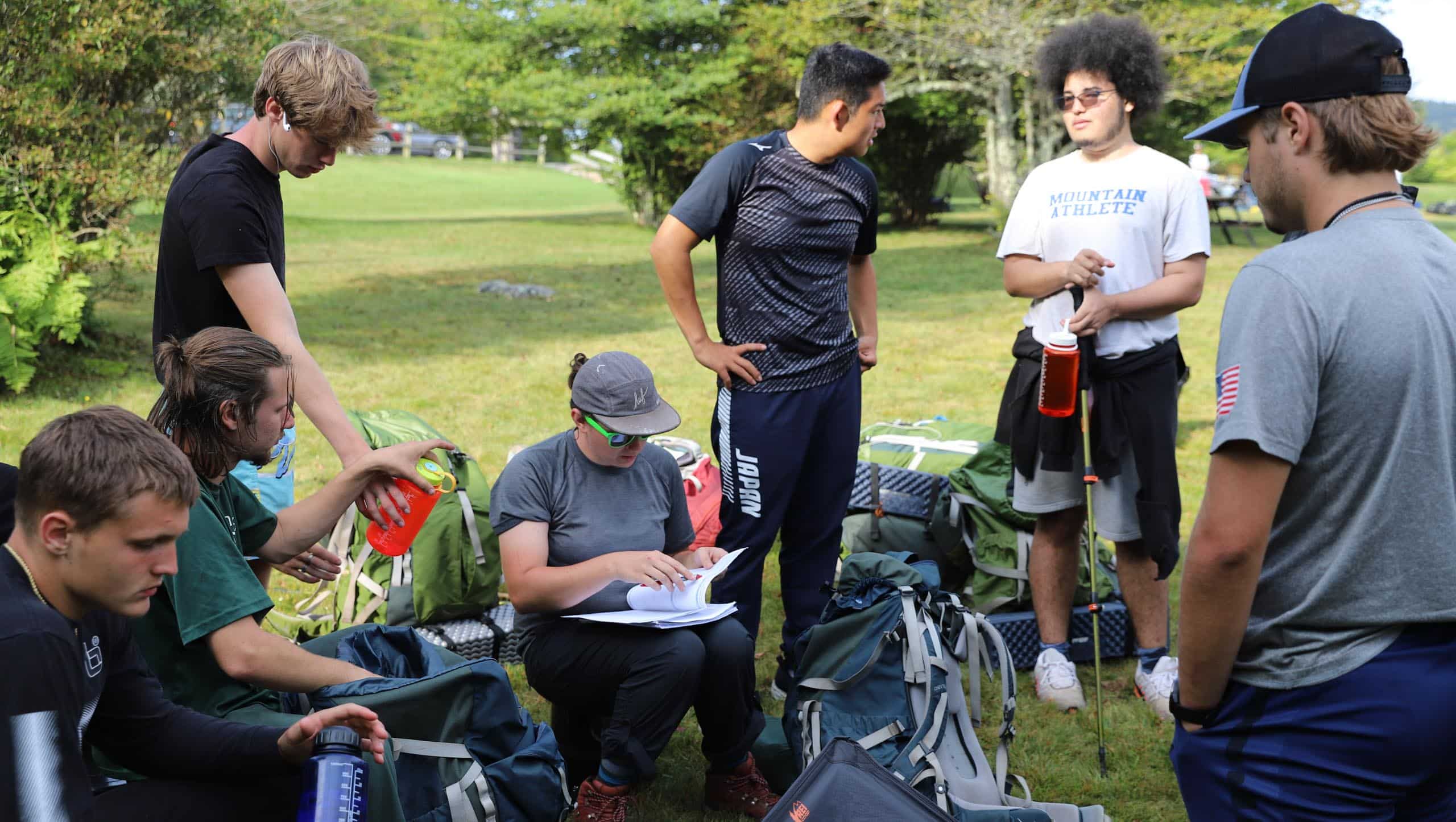 A group of people gathered with their bags and equipment.