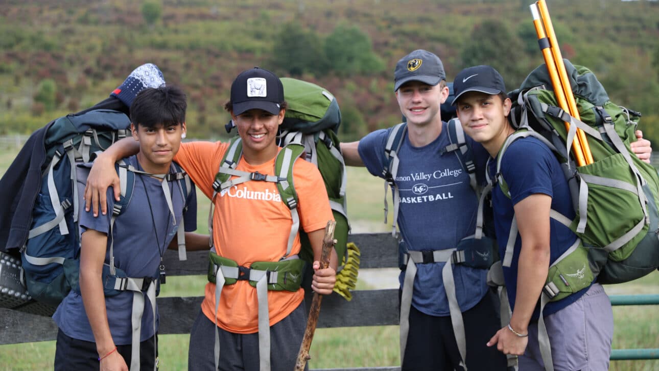 Four students wearing backpacking gear.