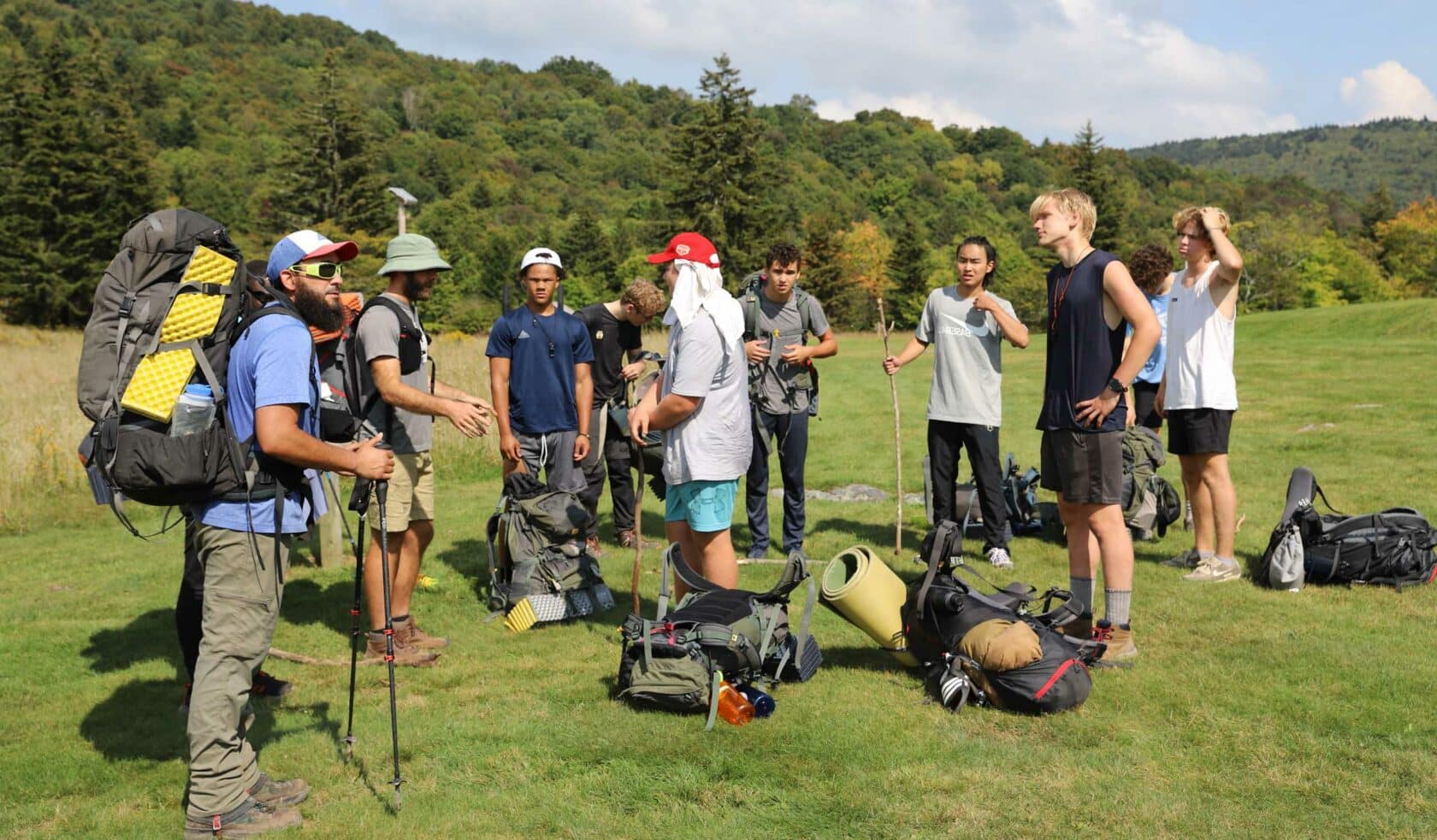 A group of people getting ready for backpacking.