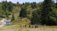 A group of people backpacking through a field.