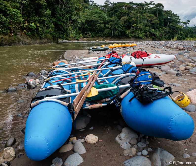 Rafts set on the shore of a river.