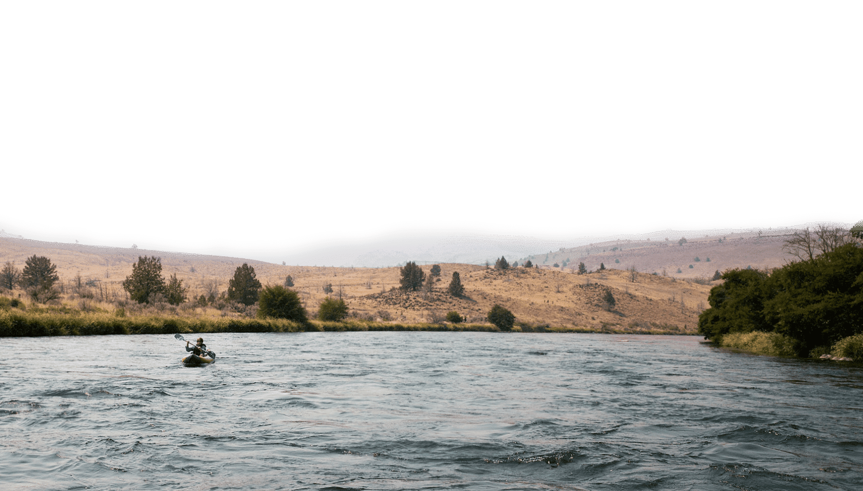 A person white water paddling.