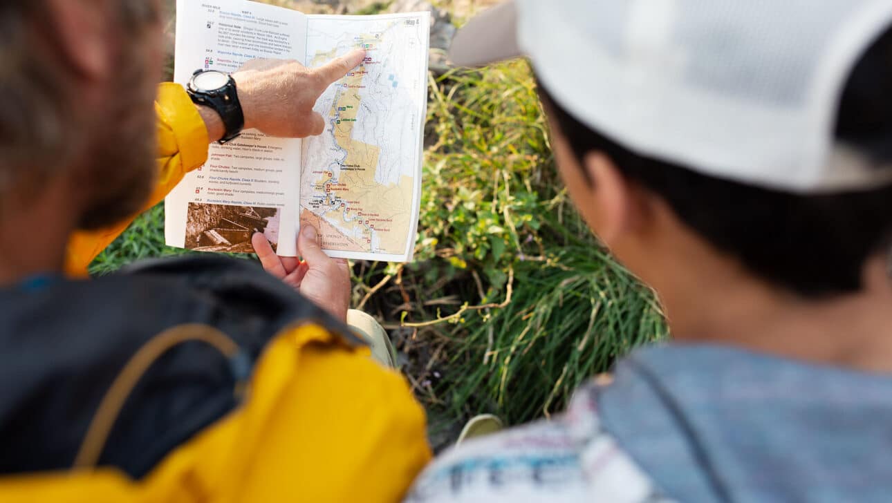 An instructor showing a student a map.