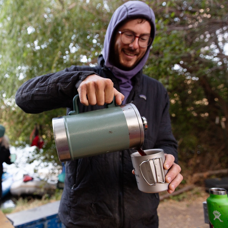 A person pouring coffee into a mug.