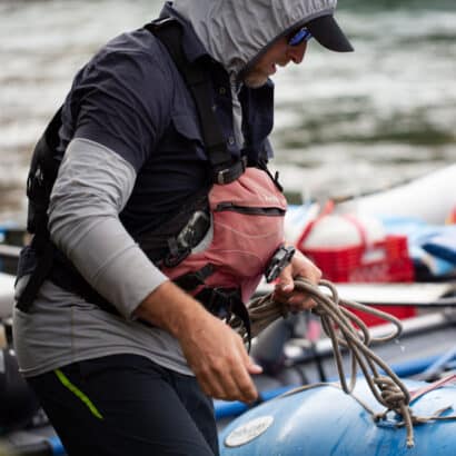 A raft guide holding equipment.