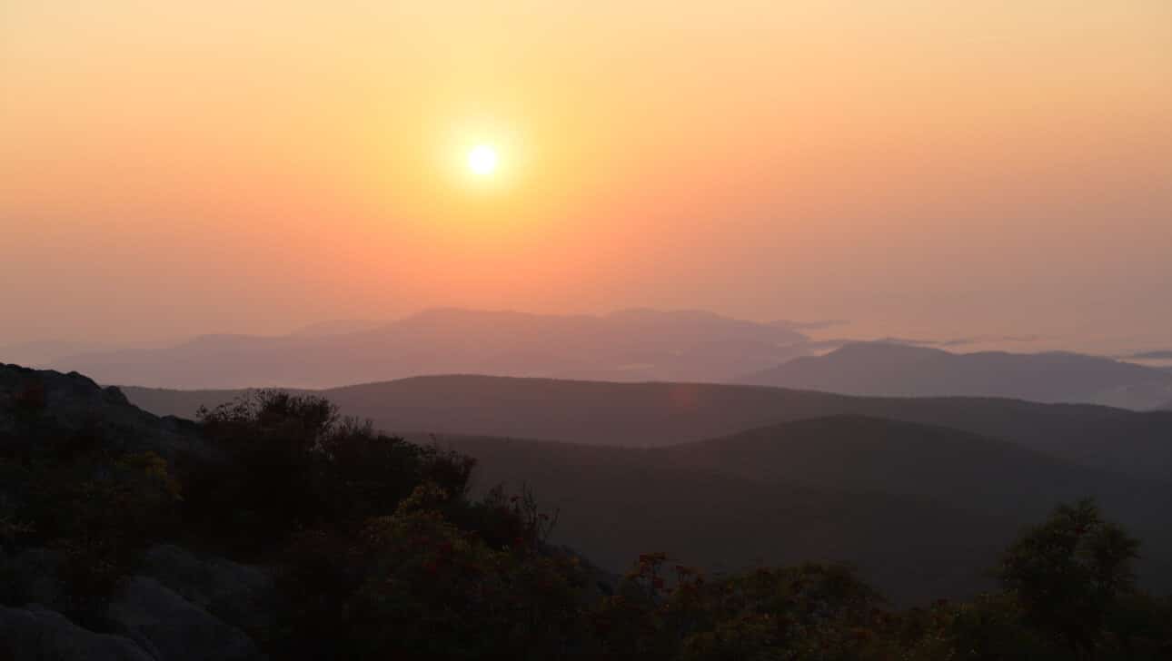 The sun setting over mountains.