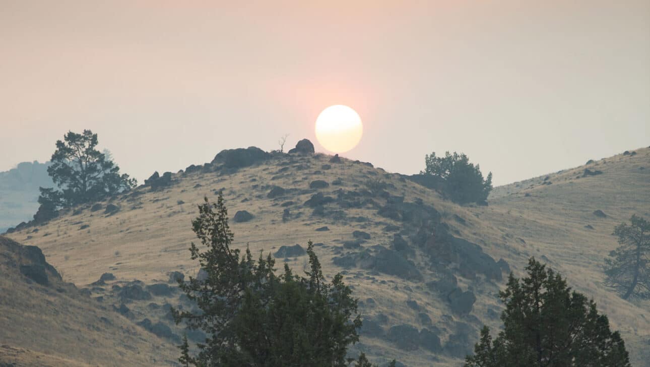 A view of a sunset over a hill.