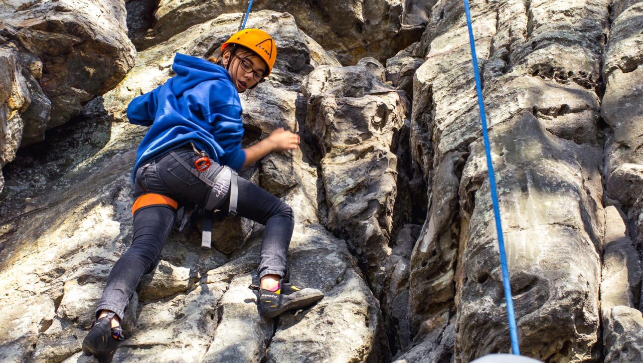 A student rockclimbing.