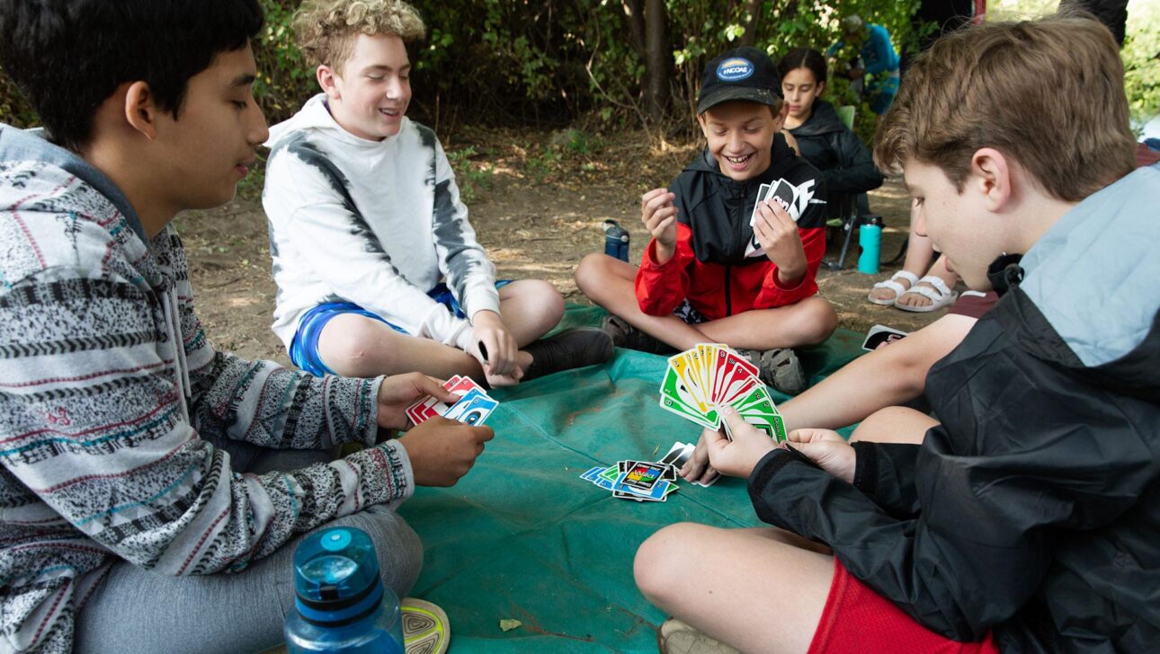 A group of students playing Uno.