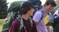 Two people wearing backpacking gear.