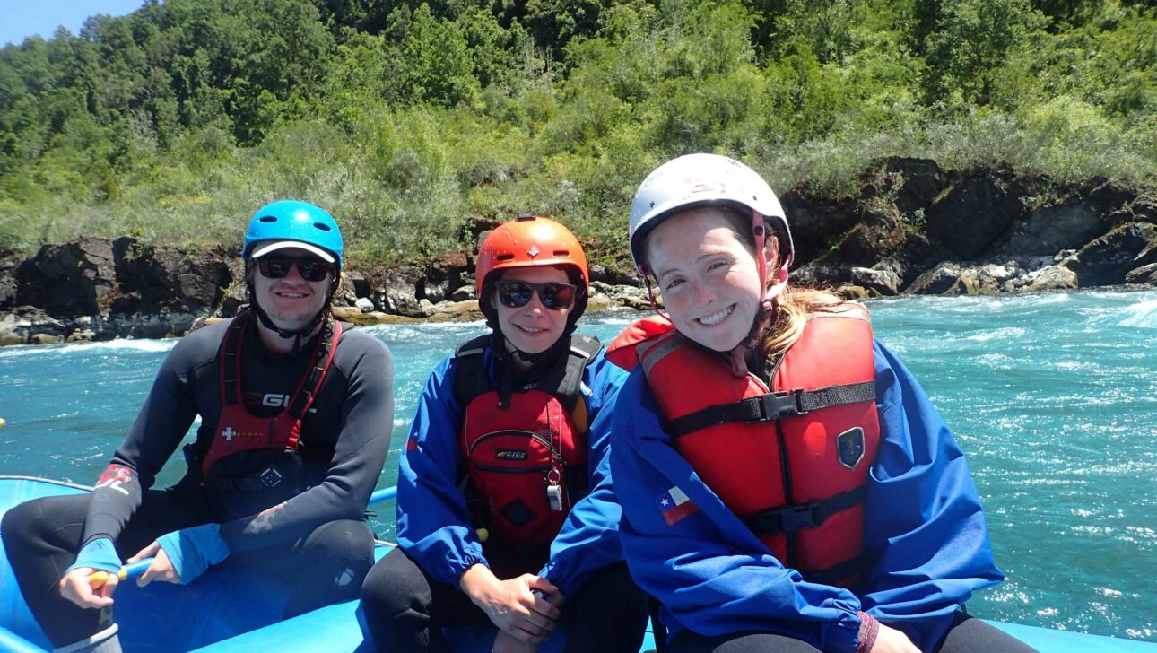 Three people on a whitewater raft.