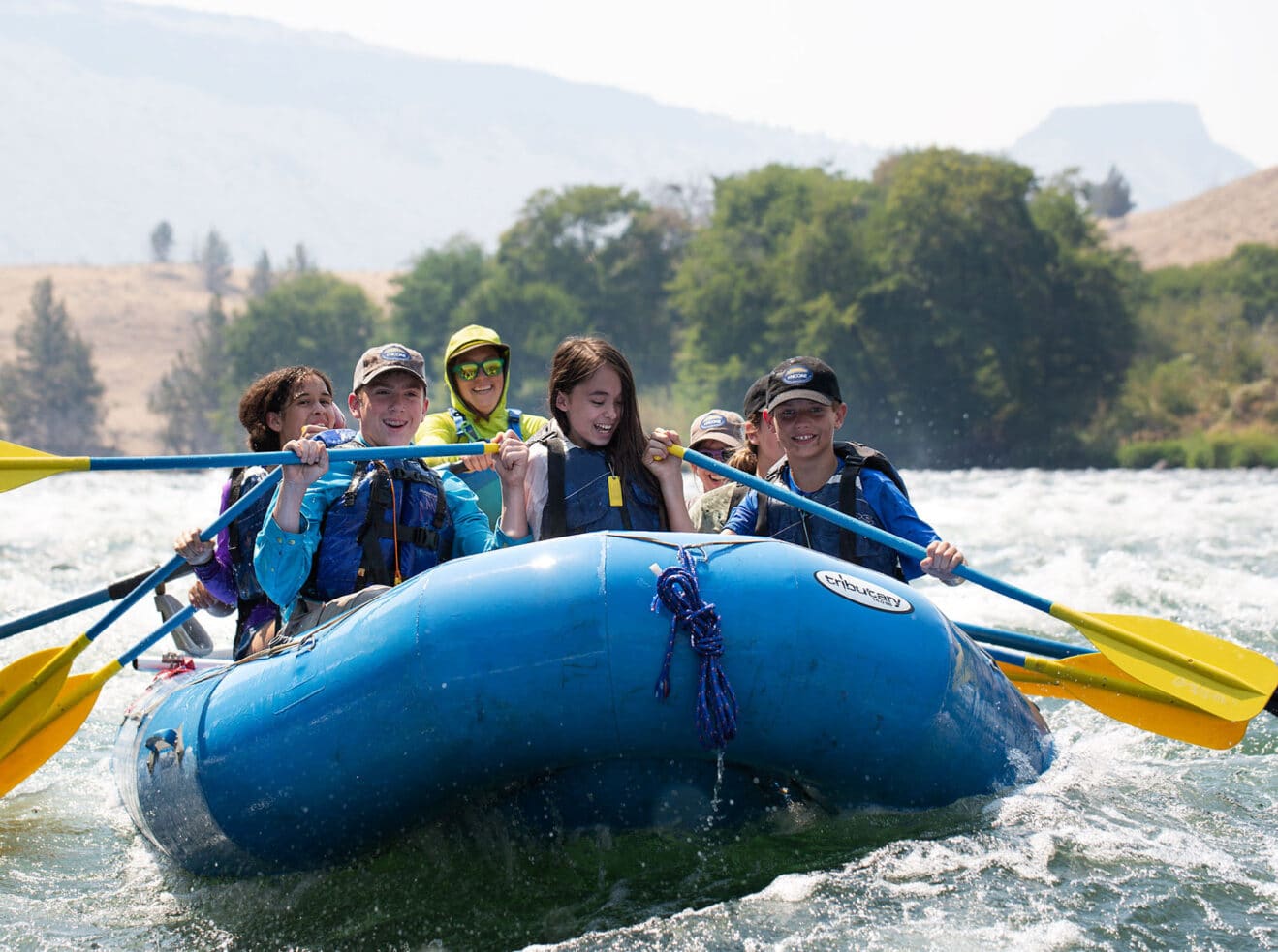 A group of students whitewater paddling.
