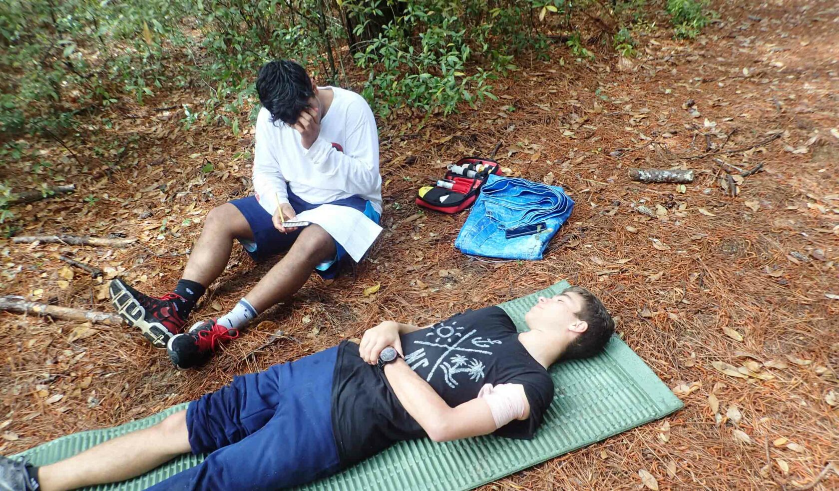 A wilderness EMT student examining a patient.