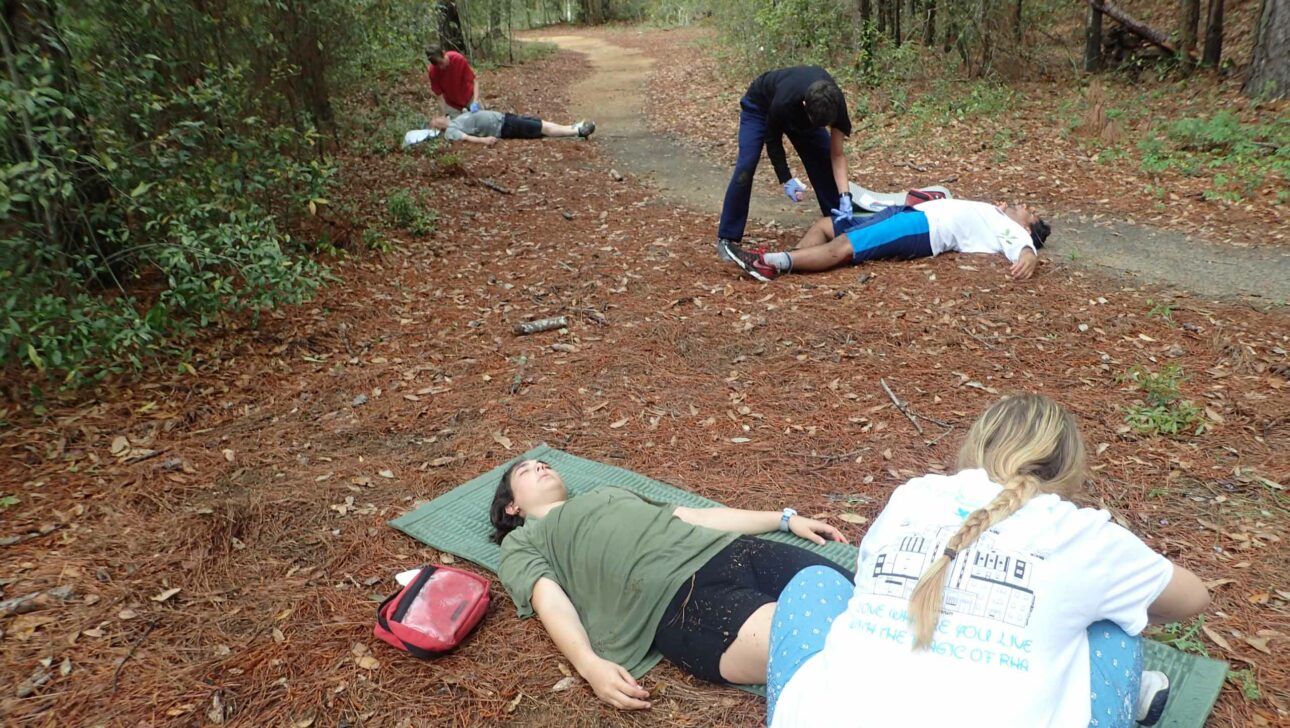 Wilderness medicine students treating injuries.