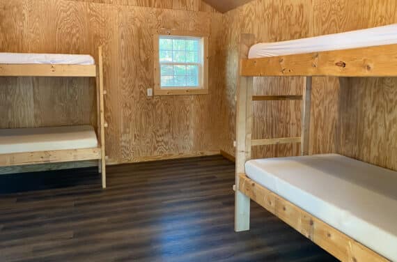 The interior of an NCOAE cabin with two bunk beds.