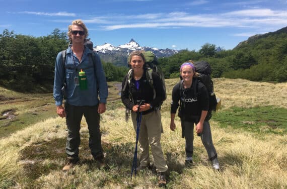 Three people backpacking.