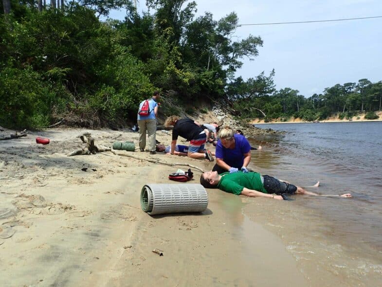 Wilderness medicine students training at a shore.