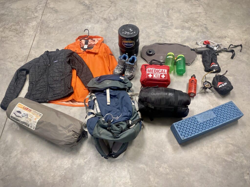 Collection of outdoor gear, including jackets, medical equipment, and backpacks, for 2024