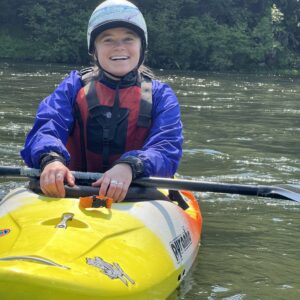 NCOAE staff member Lydia S sitting in a kayak on the water.
