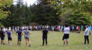 Large group of students standing in a circle at NCOAE's outdoor education training.