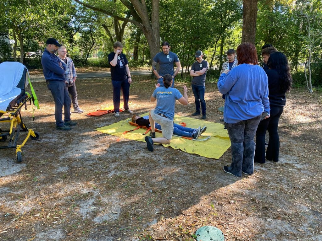 NCOAE students working on a mock spinal injury wilderness medicine training