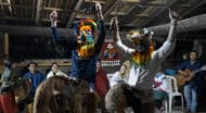 boys dancing in headgear.