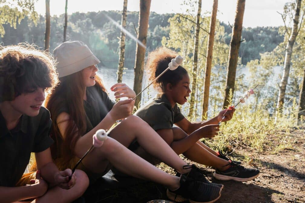 kdis roasting marshmallows in the woods.
