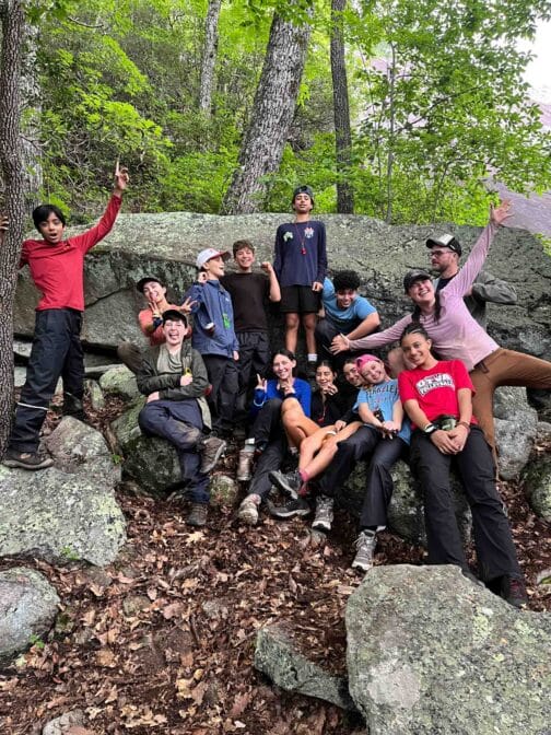 young teens posing for a picture on a hike.